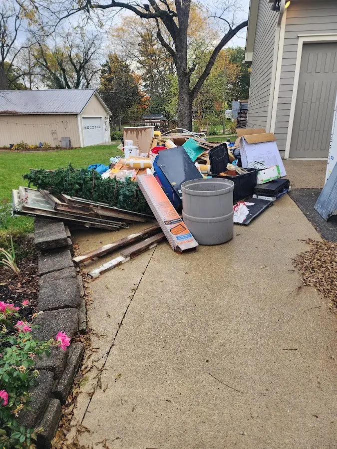 Dumpster being loaded with debris for Estate Cleanout Dumpster Rental in Douglas